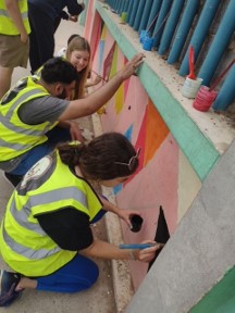 Moroccan and US students painting a school together
